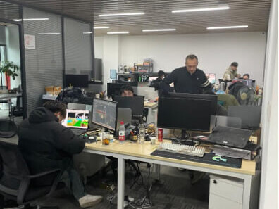 Modern warehouse control room with team of engineers monitoring multiple computer screens, dashboards, and surveillance displays for automated logistics operations
