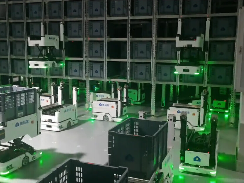 Automated warehouse robots moving storage bins in a high-density Sunlive robotic storage system